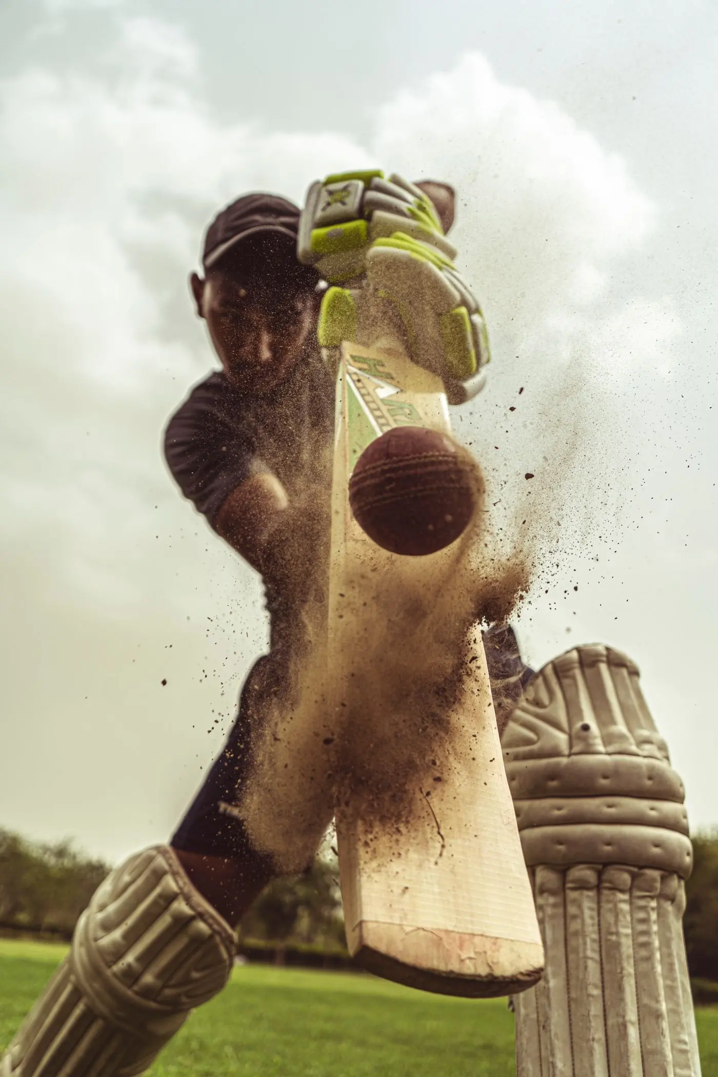 Cricketer striking the ball in match play
