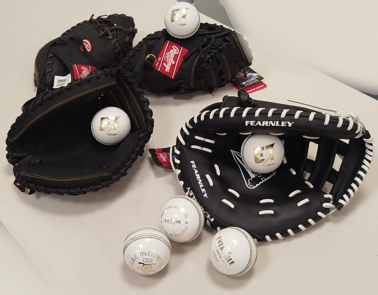 Catching mitts holding ET Premium match balls